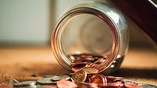 Coins coming out of a jar